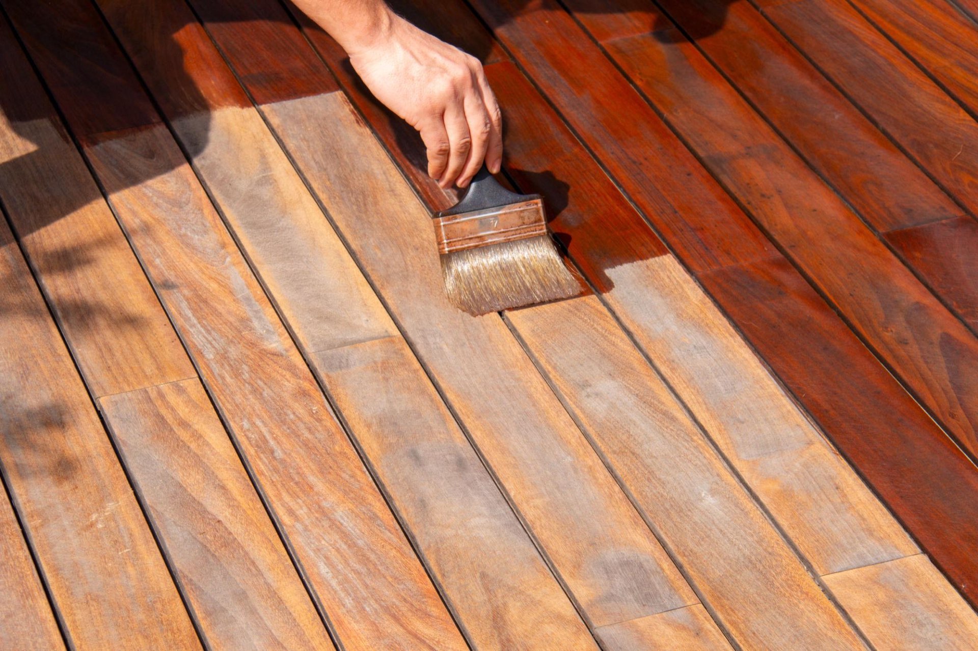Hand-applying marine-grade oil to Ipe boards in Irvine